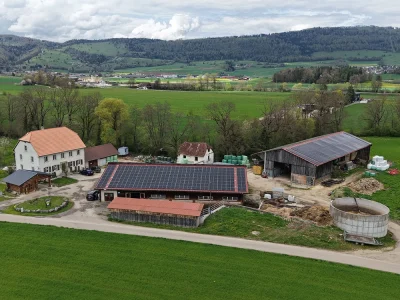 Solar panel on two farm buildings in Bassecourt, Canton Jura